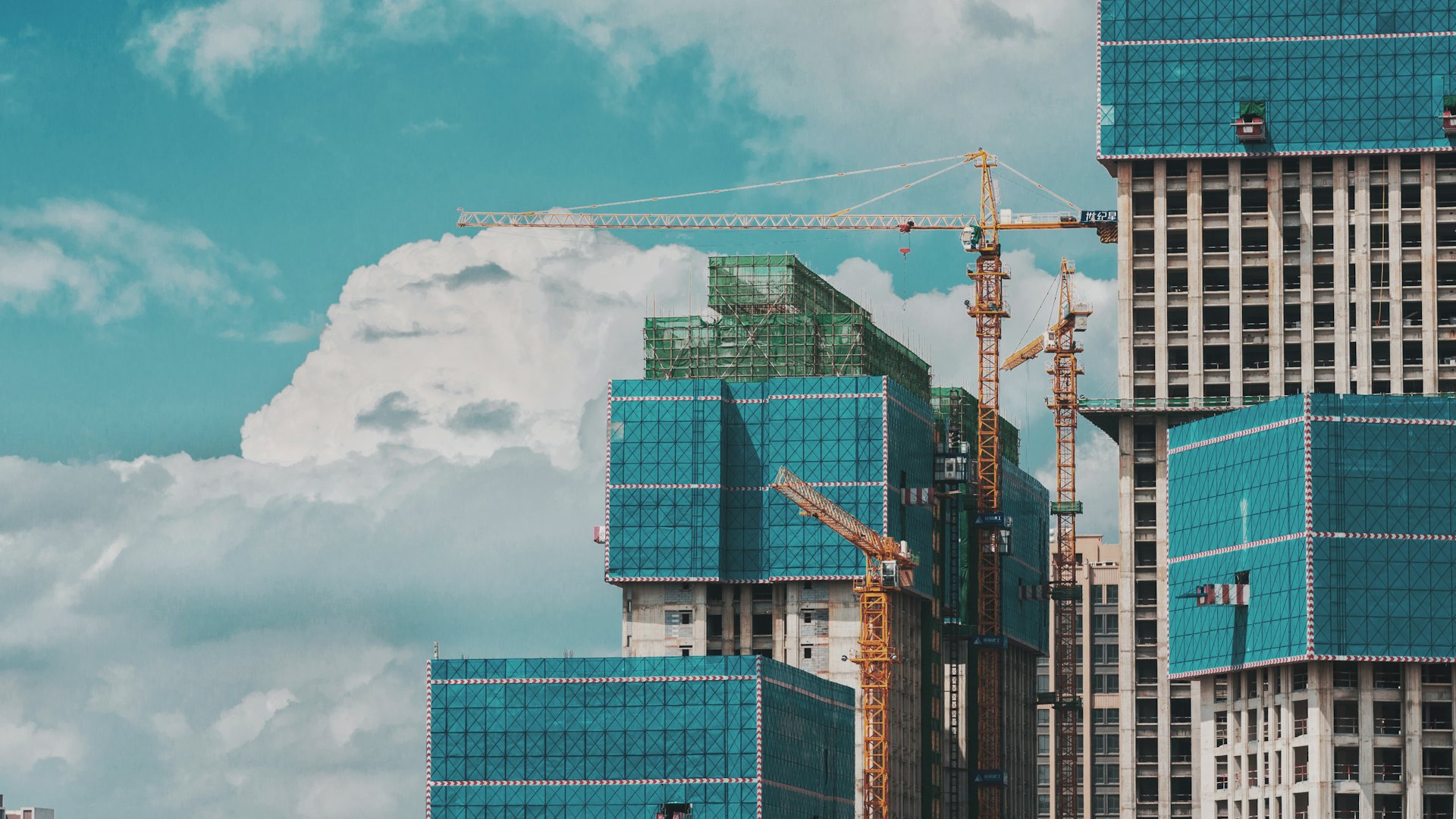 Tower cranes above a high-rise development under construction